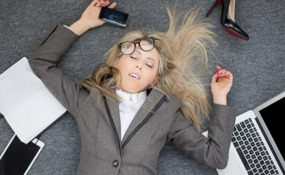 Frau liegt gestresst am Boden